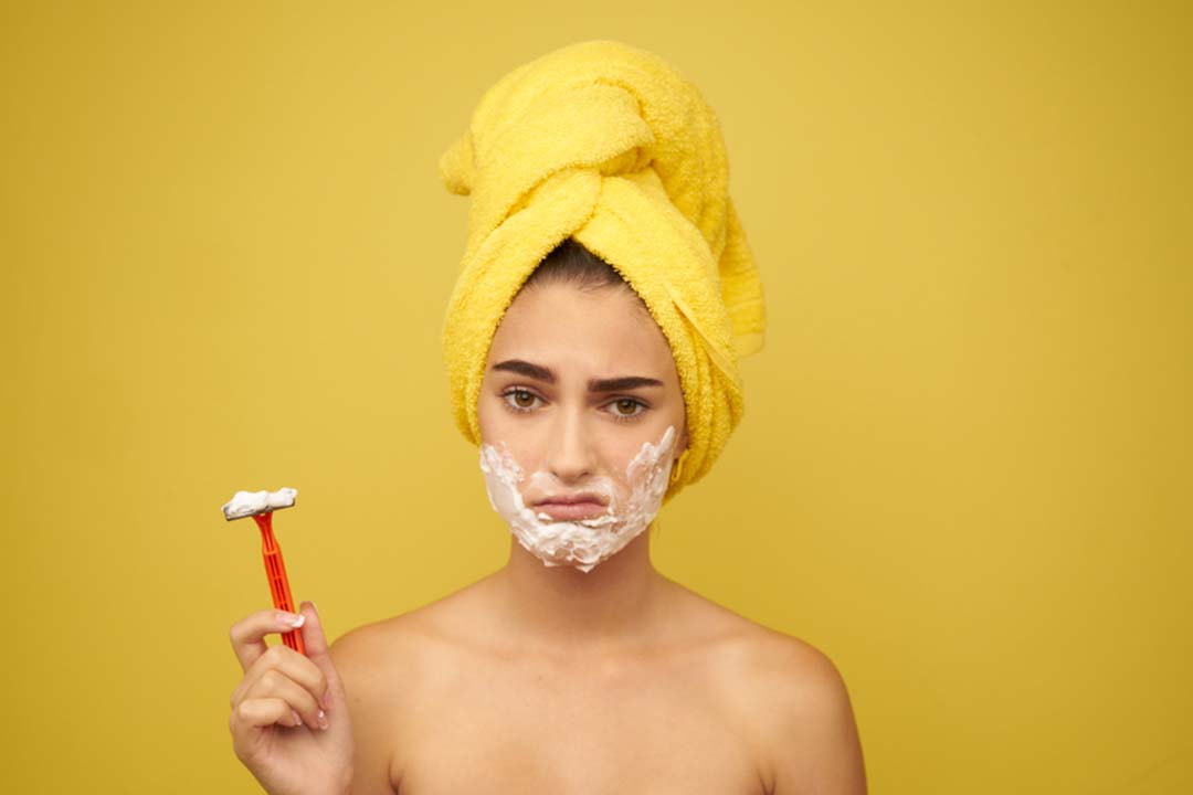 Image of a woman wrapped in a towel, displaying the results of hair removal.