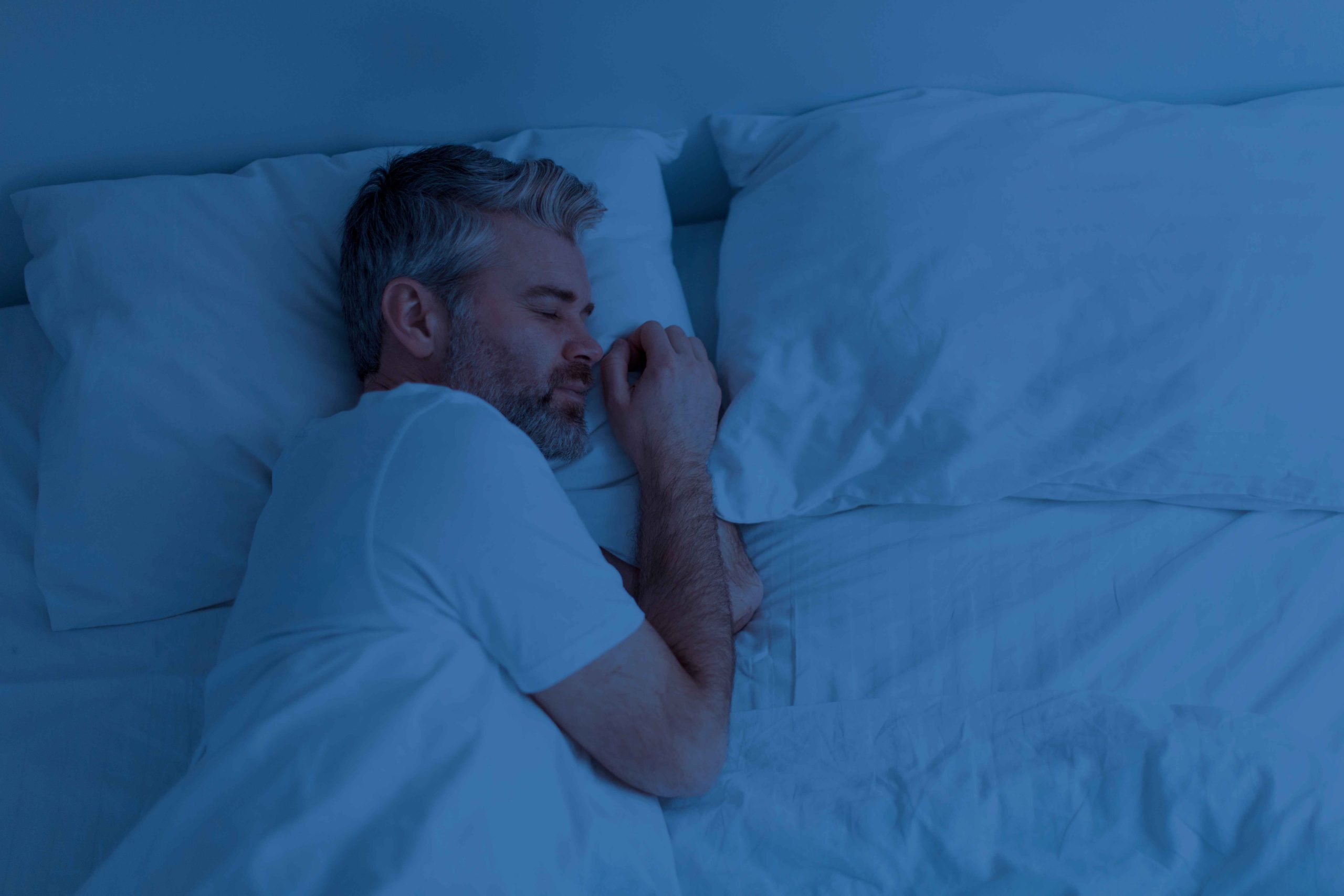 top-view-of-man-sleeping-alone-in-bed-at-night-promoting Melatonin gummies